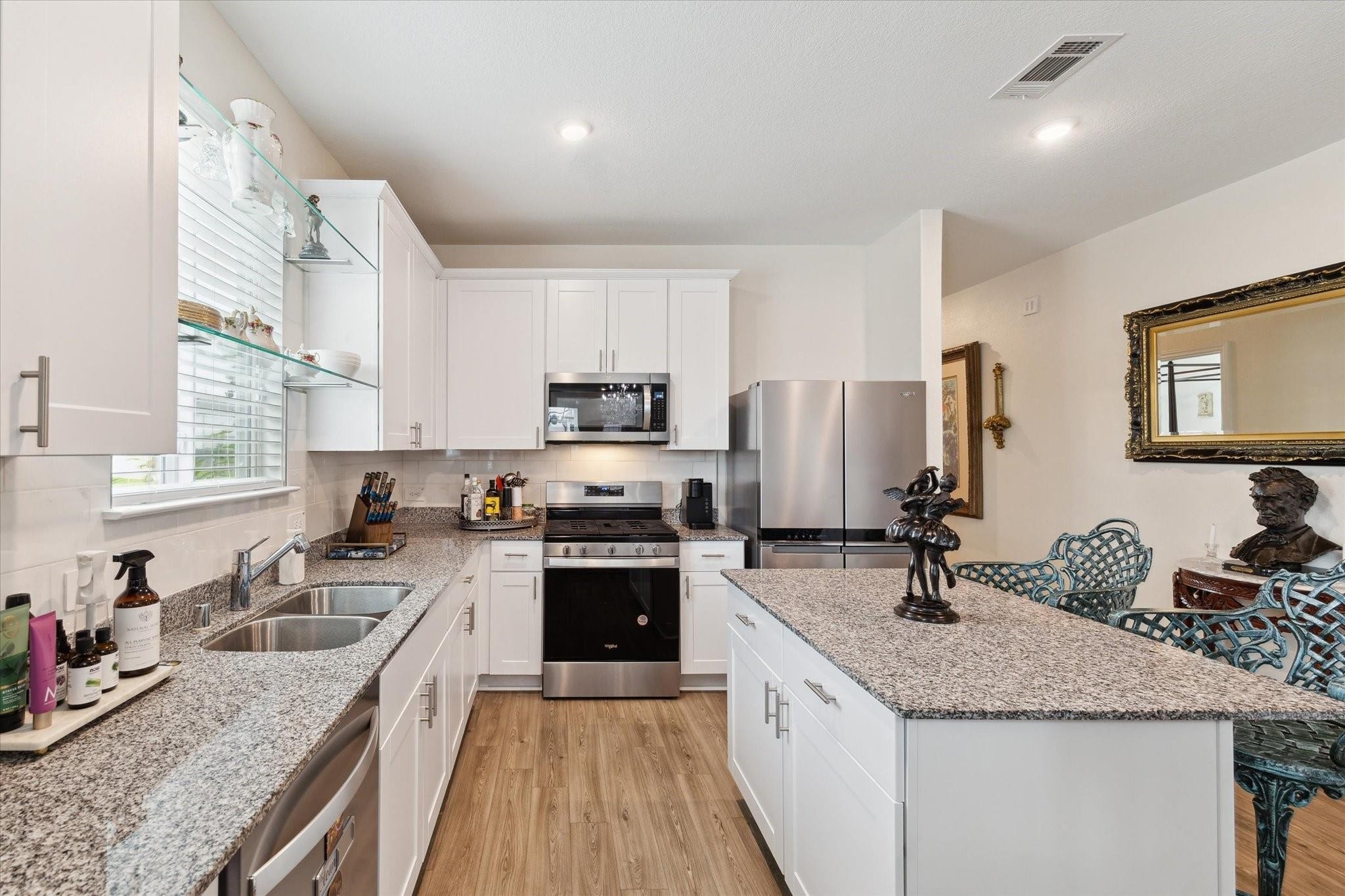 23502 Glenbuck St Spring Spring, TX 77373 - Photo 19 of 21 a kitchen with a sink stove top oven and refrigerator