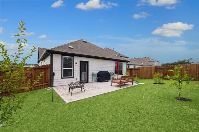 a front view of house with a garden and patio