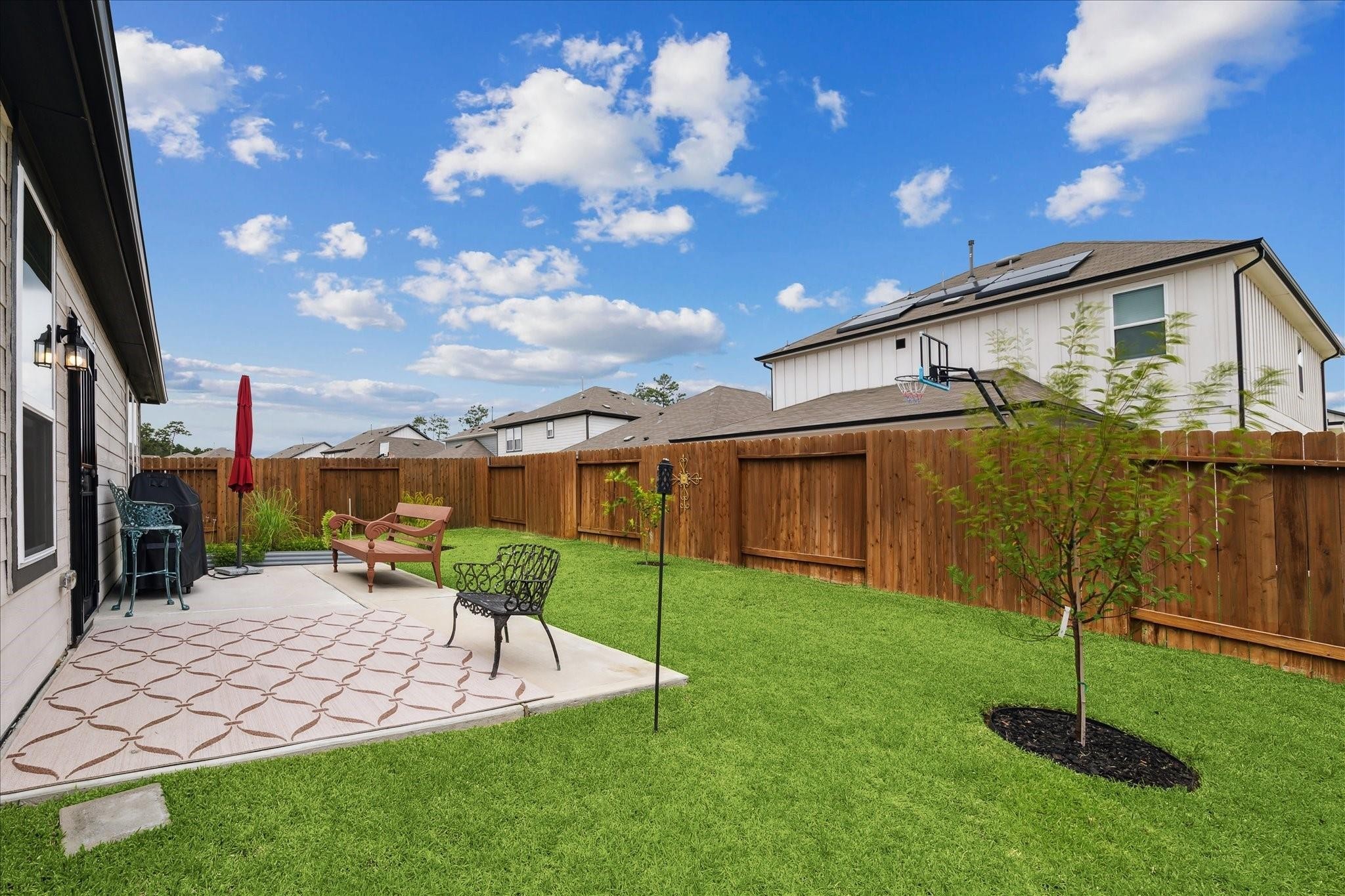 23502 Glenbuck St Spring Spring, TX 77373 - Photo 3 of 21 a view of a chair and table in backyard of the house
