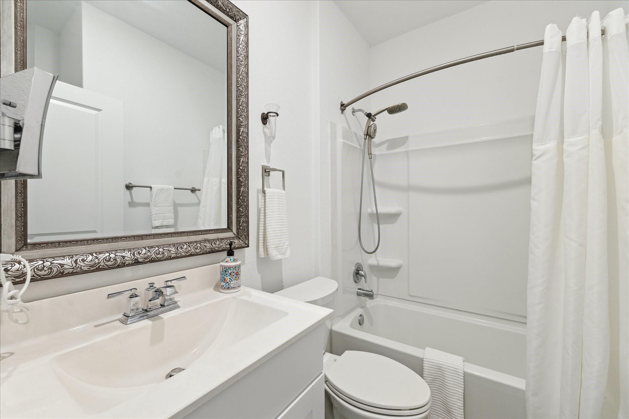 23502 Glenbuck St Spring Spring, TX 77373 - Photo 7 of 21 a bathroom with a sink toilet and shower