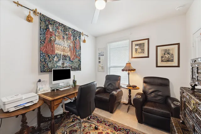 a livingroom with workspace and a couch