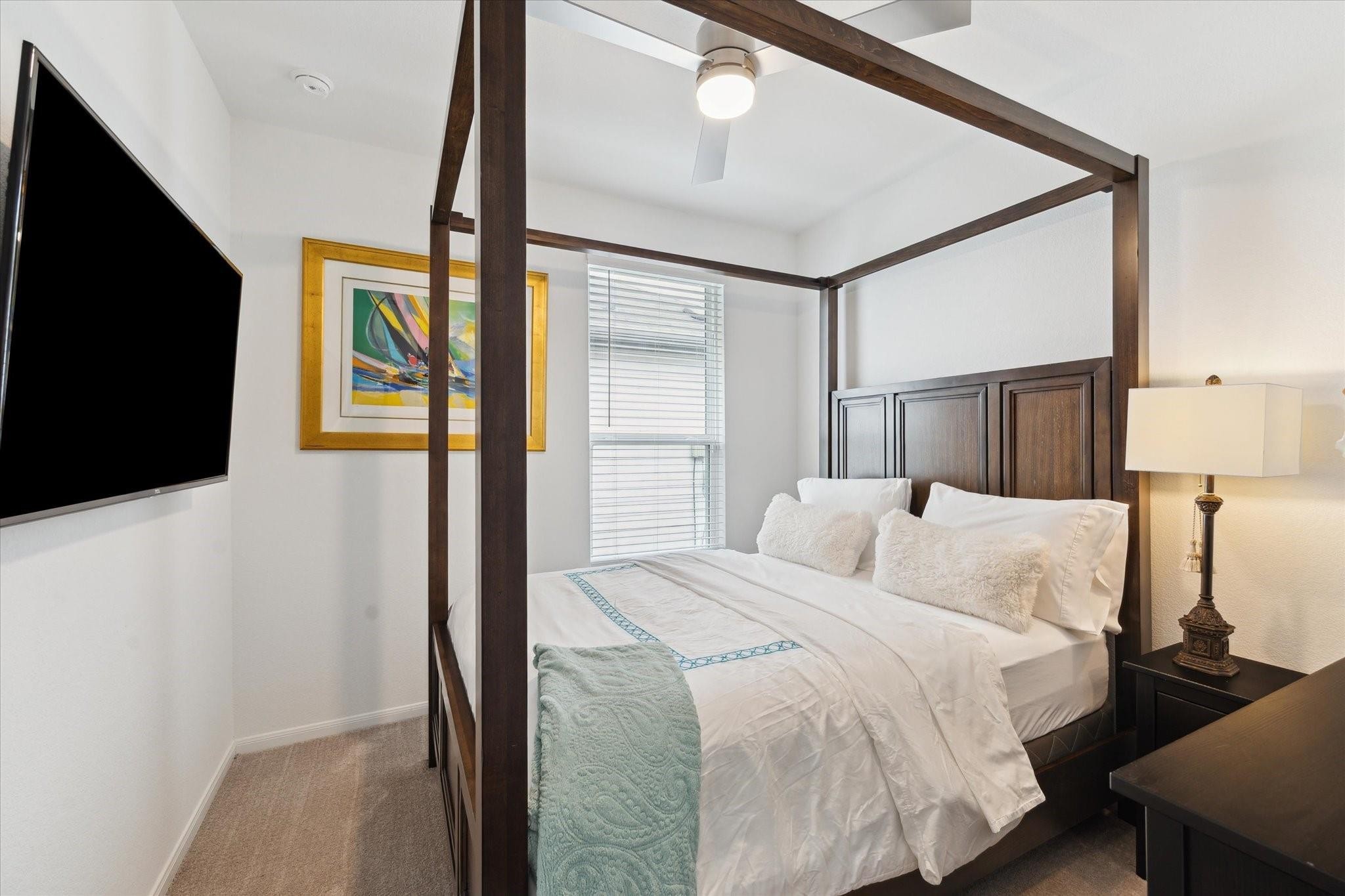 23502 Glenbuck St Spring Spring, TX 77373 - Photo 9 of 21 a bedroom with a bed and a flat tv screen on dresser
