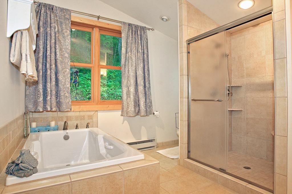398 George Reed Lane Northwest Floyd, VA 24091 - Photo 21 of 61 a bathroom with a tub and a sink
