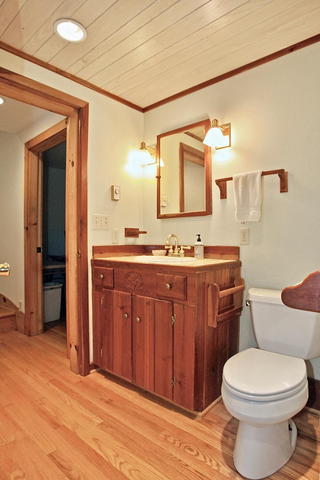 398 George Reed Lane Northwest Floyd, VA 24091 - Photo 26 of 61 a bathroom with a granite countertop toilet sink and mirror