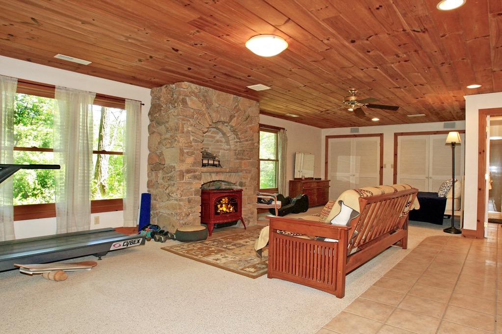 398 George Reed Lane Northwest Floyd, VA 24091 - Photo 38 of 61 a living room with furniture large windows and a fireplace