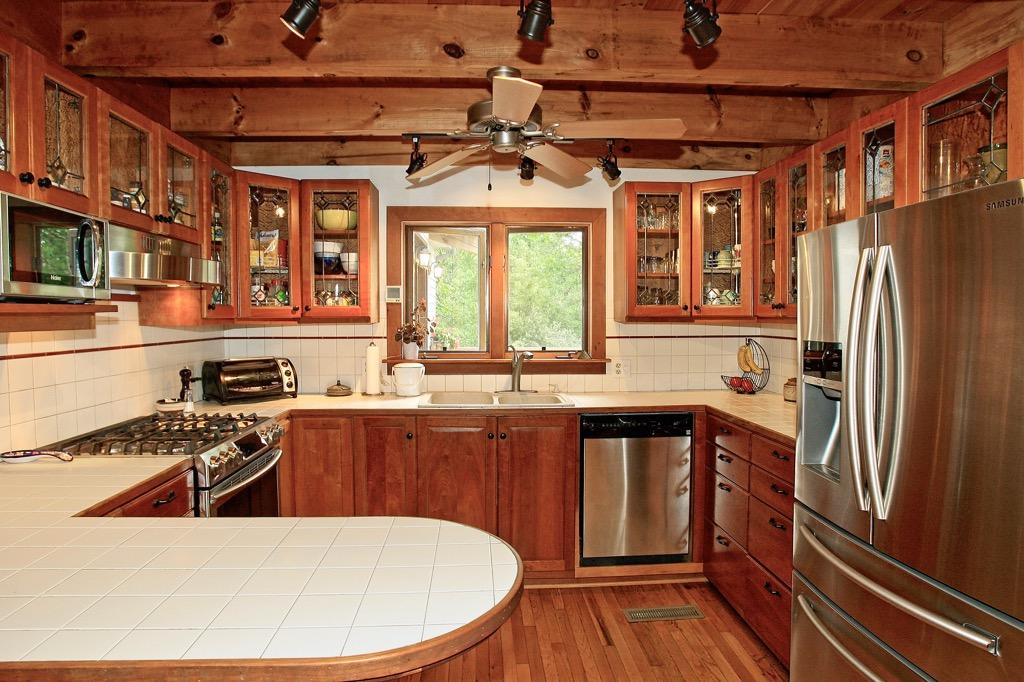 398 George Reed Lane Northwest Floyd, VA 24091 - Photo 5 of 61 a kitchen with stainless steel appliances granite countertop a refrigerator a sink dishwasher a stove and white countertops with wooden floor