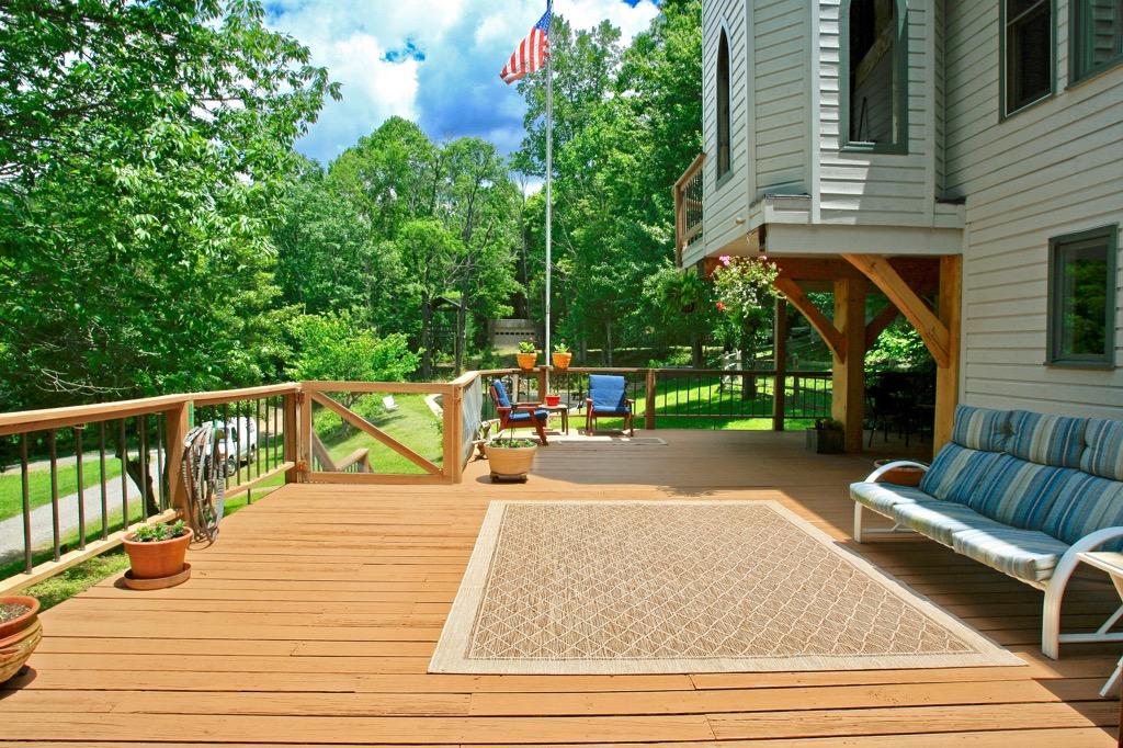398 George Reed Lane Northwest Floyd, VA 24091 - Photo 43 of 61 a view of a deck with couches with wooden floor and fence