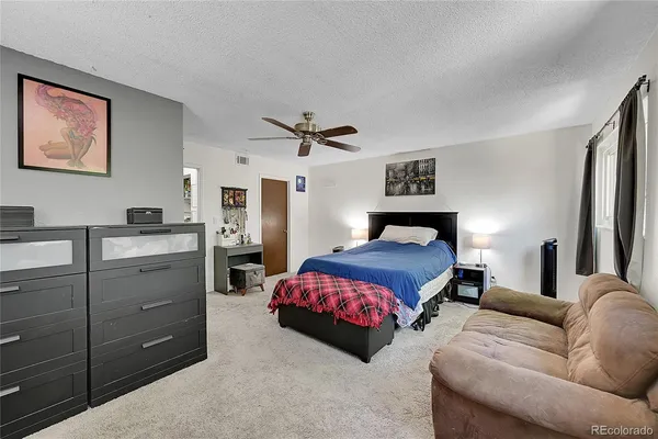a bedroom with furniture and a chandelier