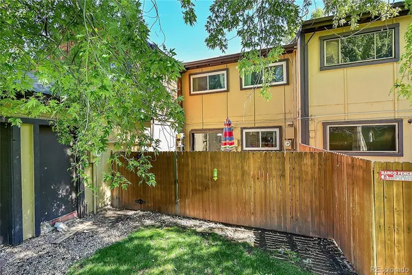 a view of a back yard with a wooden fence