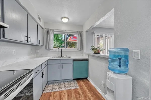 a kitchen with stainless steel appliances granite countertop a sink stove and cabinets