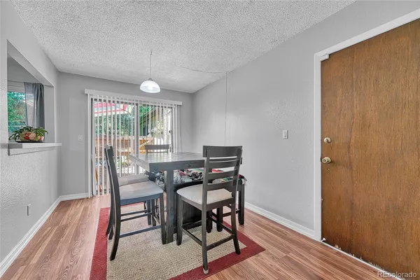 a view of a dining room with furniture window and wooden floor