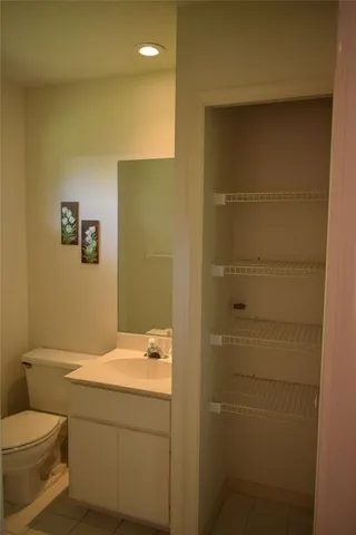 a kitchen with granite countertop a sink and a refrigerator