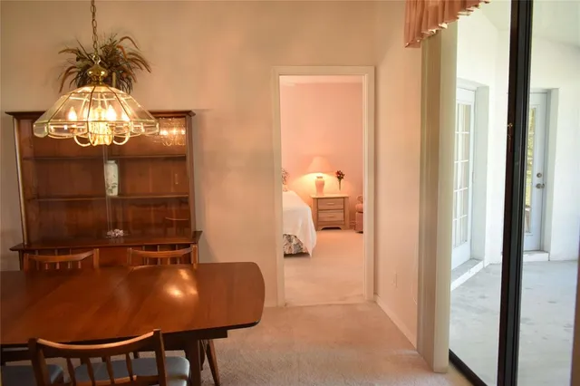 a view of a dining room with furniture and chandelier