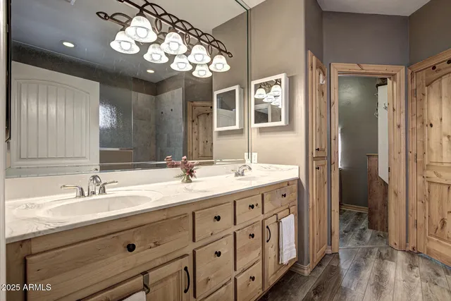 a bathroom with double vanity sink and a mirror