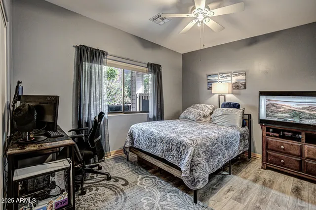 a bedroom with a bed and a chandelier