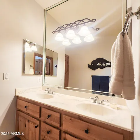 a bathroom with a double vanity sink and mirror