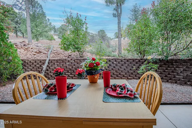 a view of roof deck with table and chairs potted plants