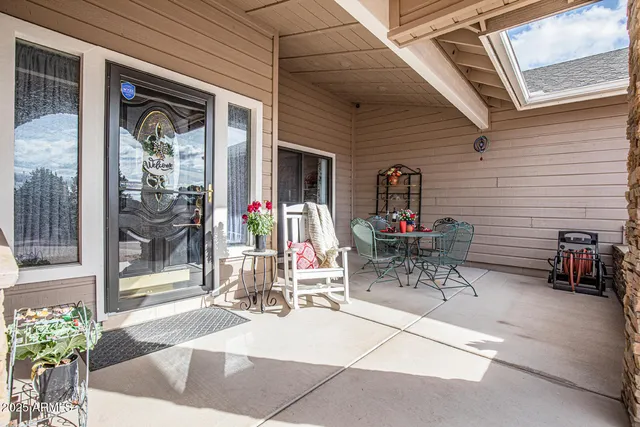 a view of house with patio outdoor dining table and chairs