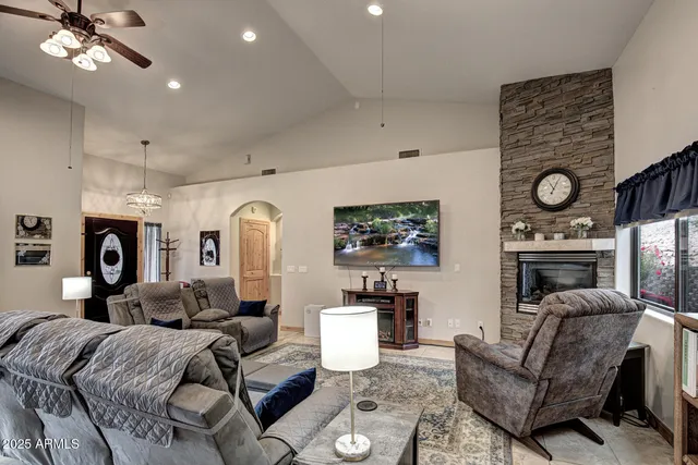 a living room with furniture a fireplace and a window