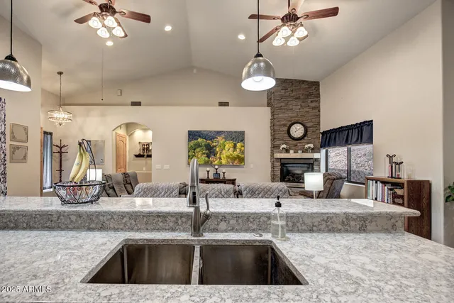 a kitchen with kitchen island granite countertop a sink and a counter top space