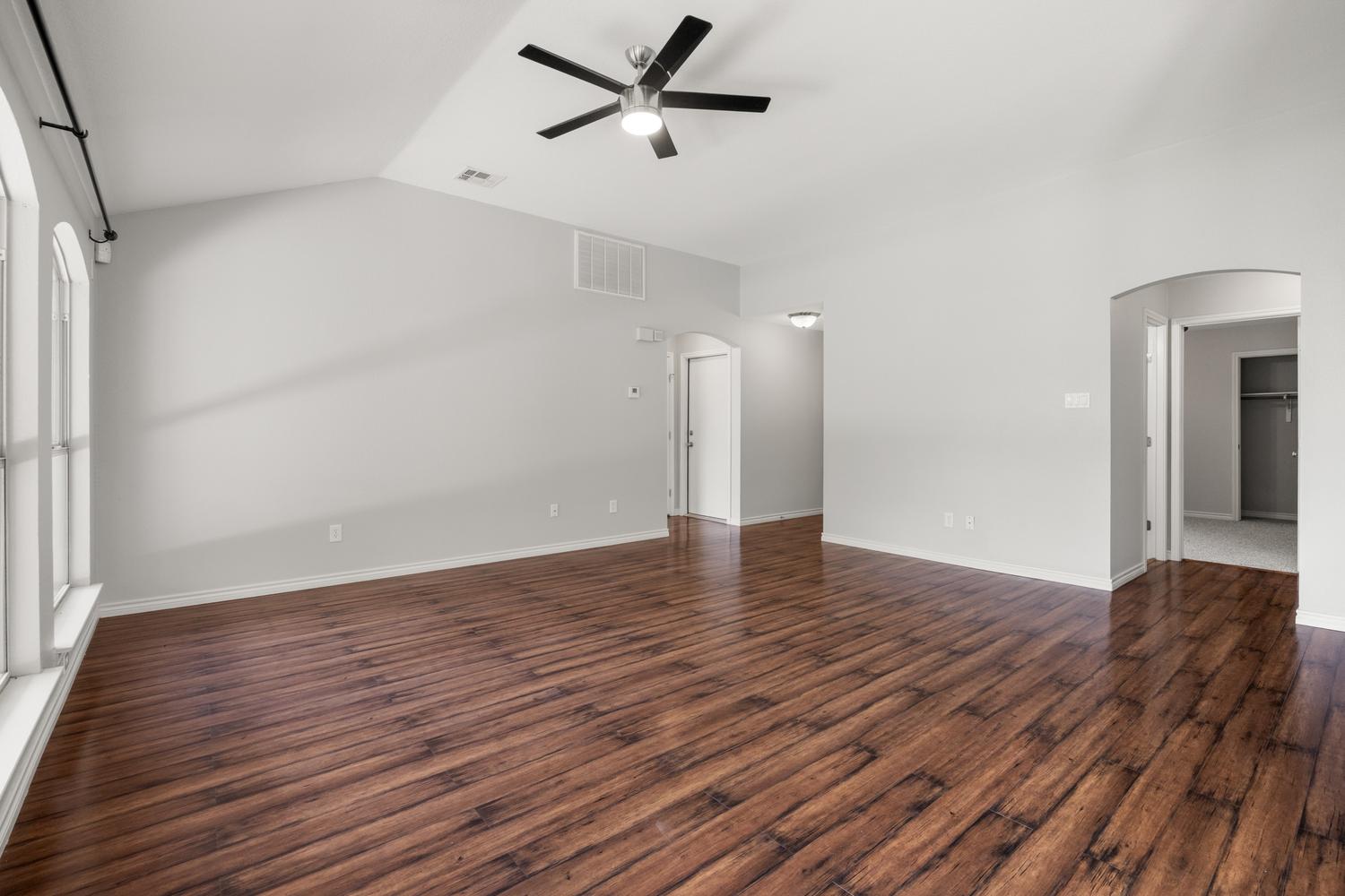 521 Britni Loop Kyle, TX 78640 - Photo 6 of 23 a view of empty room with wooden floor and fan