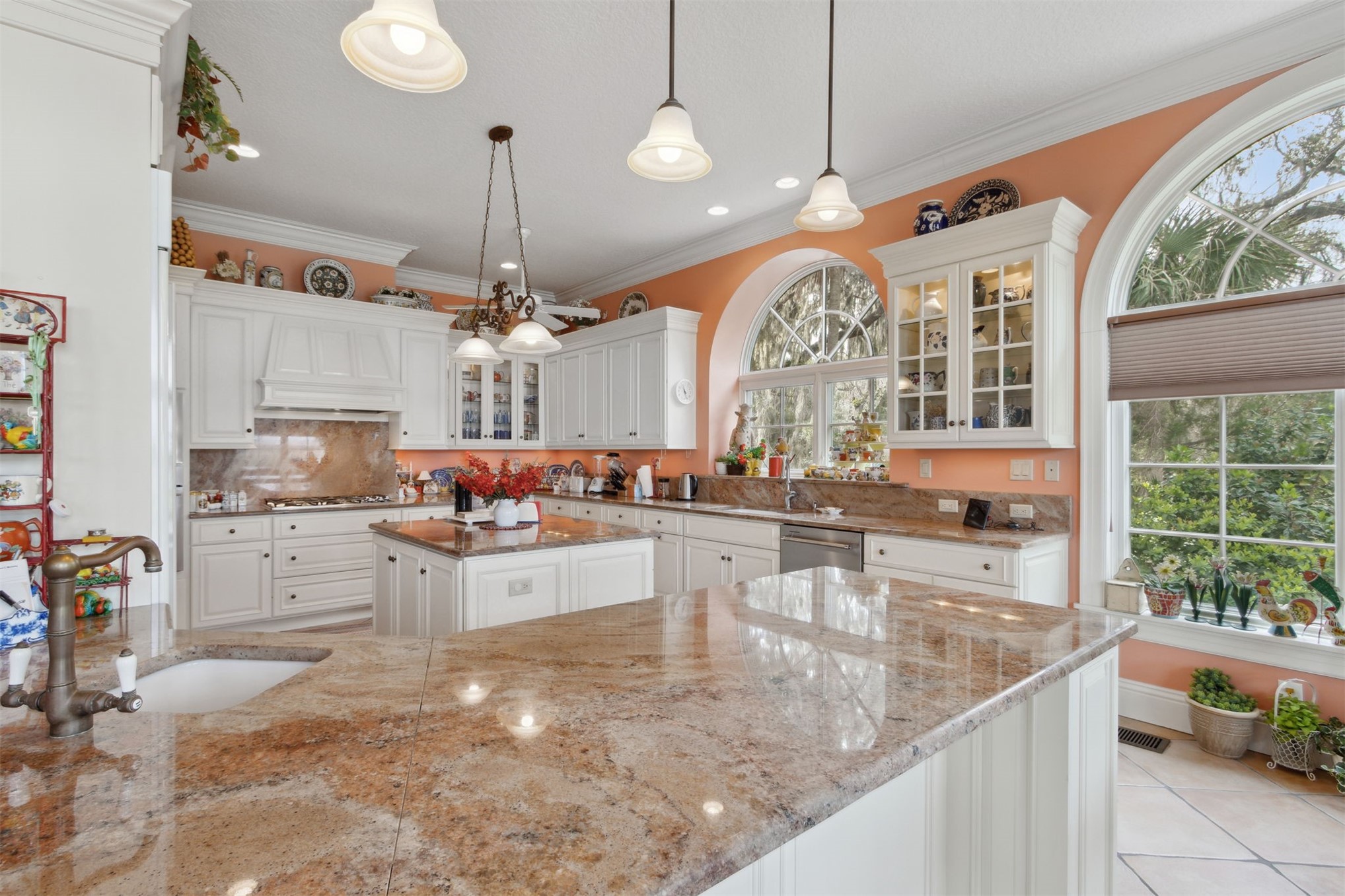 76 Marsh Creek Road Amelia Island, FL 32034 - Photo 18 of 100 a large kitchen with kitchen island a large counter top space a sink appliances and a large window