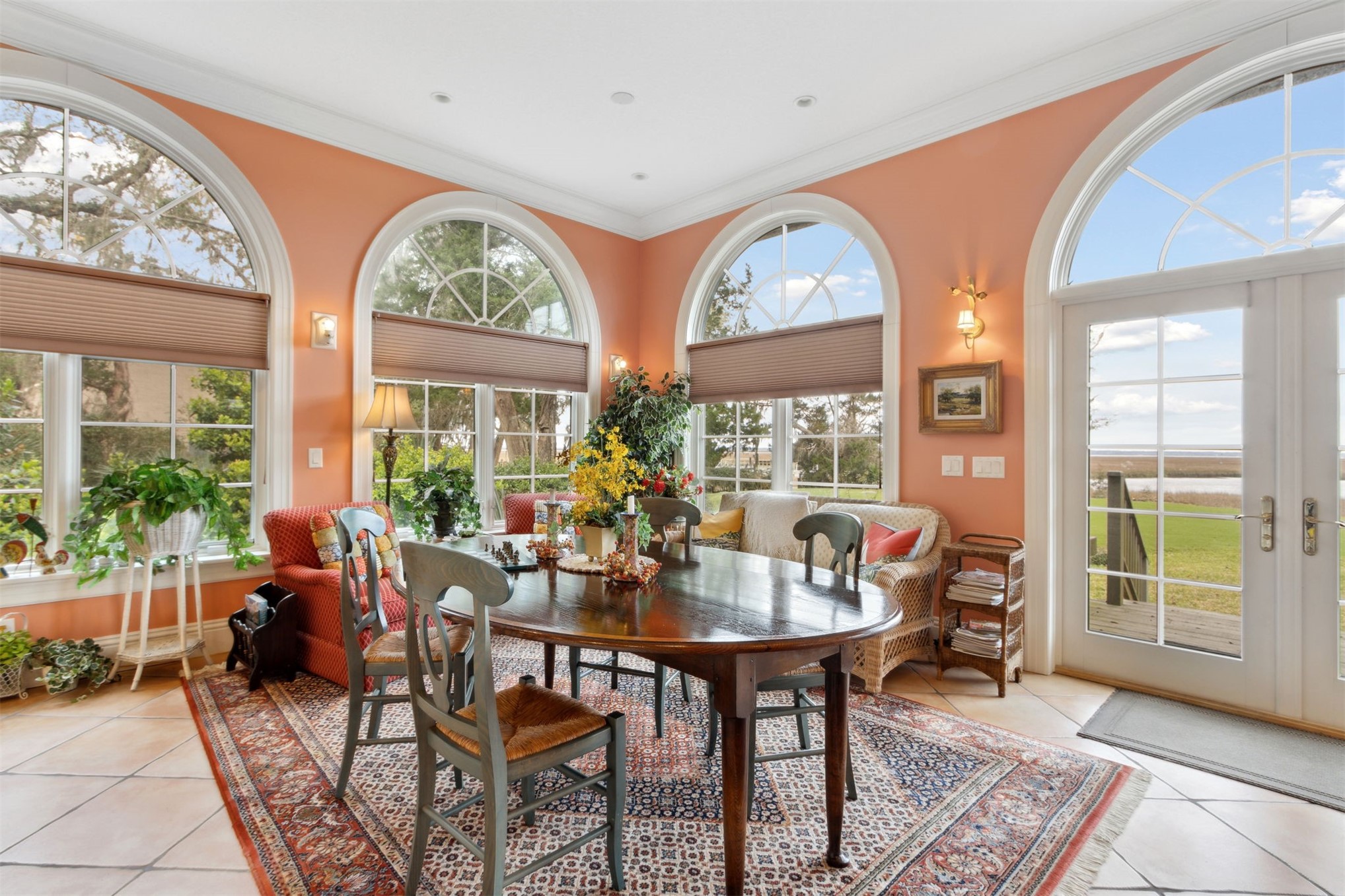 76 Marsh Creek Road Amelia Island, FL 32034 - Photo 24 of 100 a dining room with furniture a rug and a floor to ceiling window