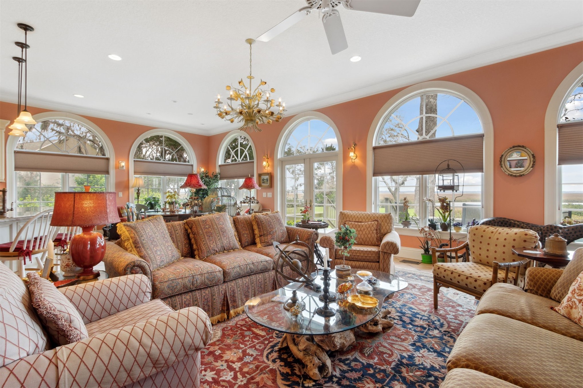 76 Marsh Creek Road Amelia Island, FL 32034 - Photo 27 of 100 a living room with furniture a large window and a chandelier