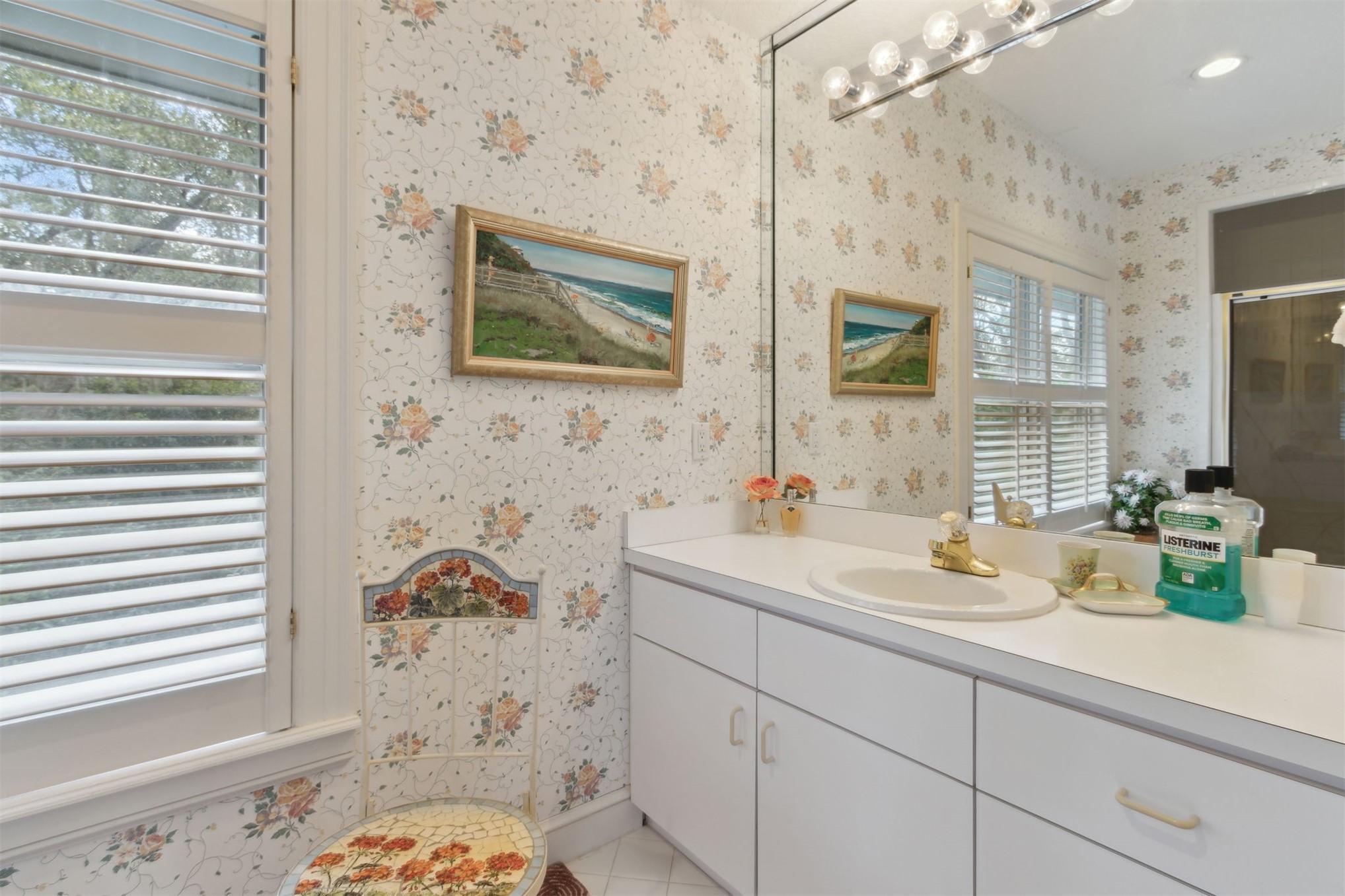 76 Marsh Creek Road Amelia Island, FL 32034 - Photo 59 of 100 a bathroom with a sink a mirror and next to a window