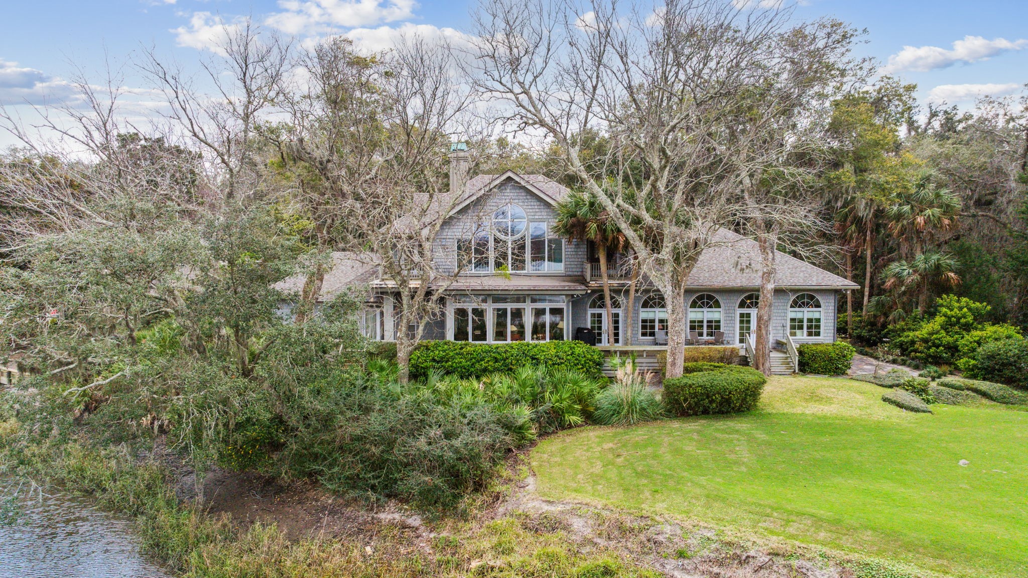76 Marsh Creek Road Amelia Island, FL 32034 - Photo 74 of 100 a front view of a house with a garden