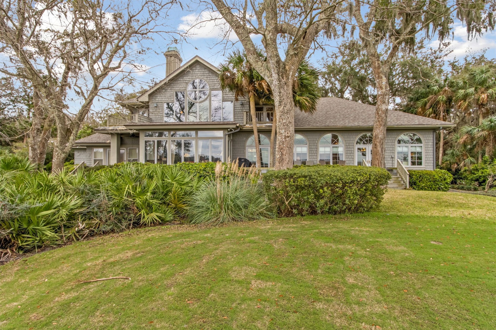76 Marsh Creek Road Amelia Island, FL 32034 - Photo 76 of 100 a front view of a house with a garden
