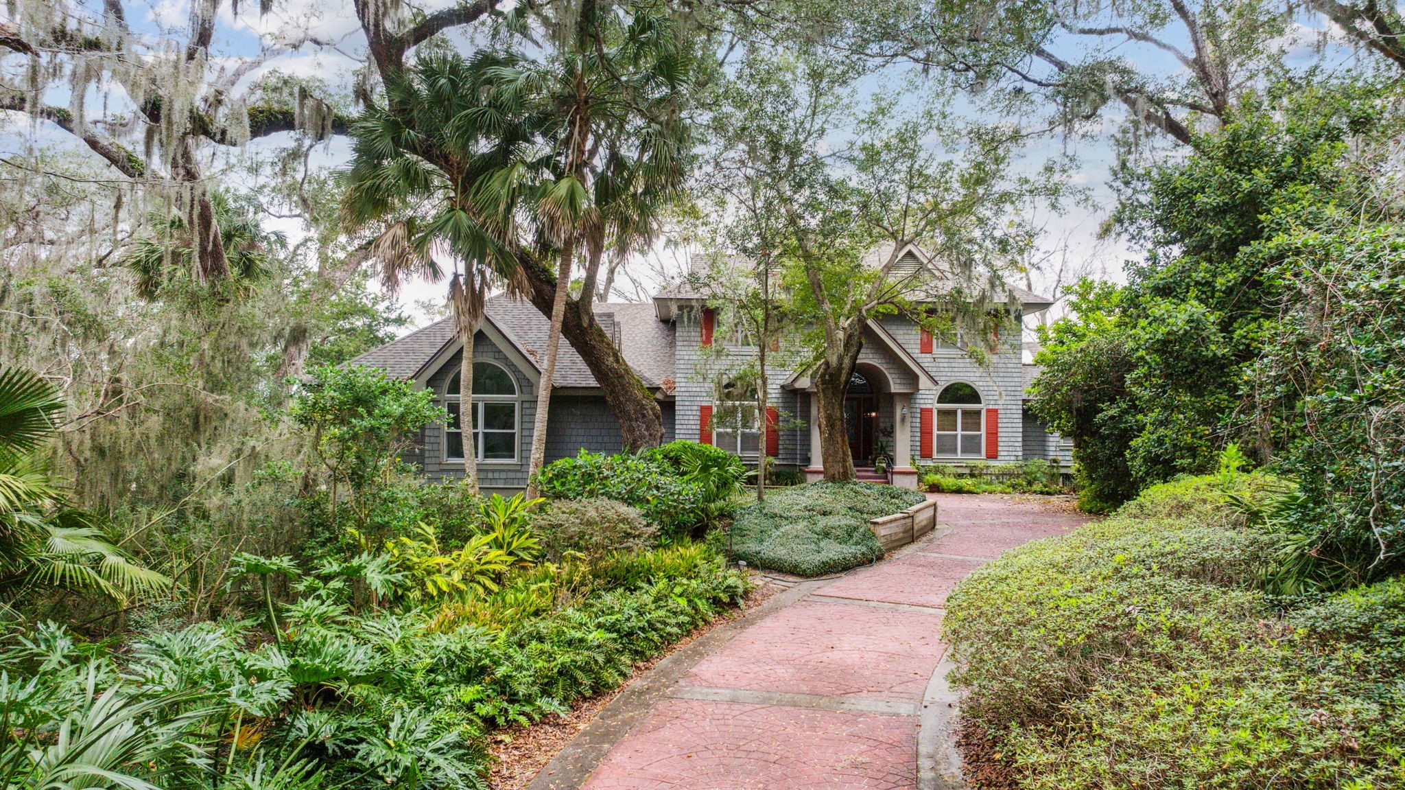 76 Marsh Creek Road Amelia Island, FL 32034 - Photo 84 of 100 a front view of a house with a yard and trees