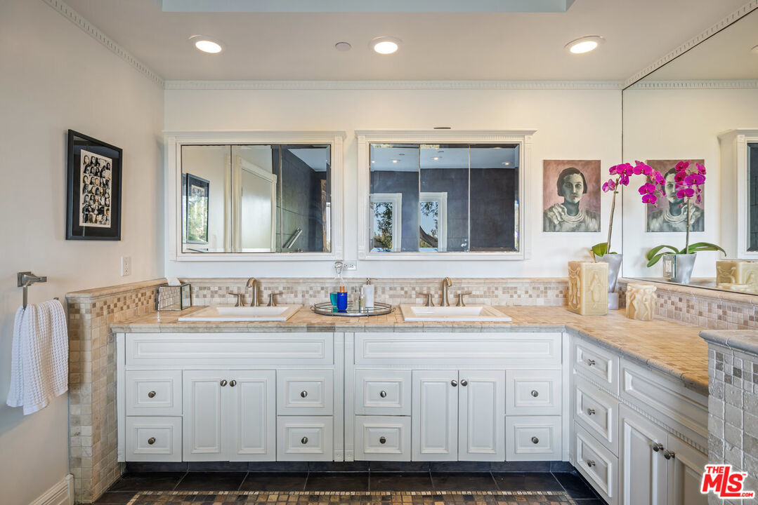 7770 Firenze Avenue Los Angeles, CA 90046 - Photo 16 of 32 a bathroom with a sink double vanity and a mirror
