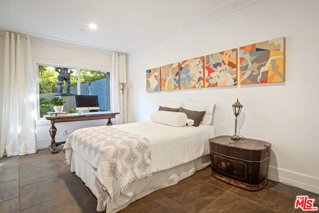 7770 Firenze Avenue Los Angeles, CA 90046 - Photo 21 of 32 a bedroom with a bed and a large window