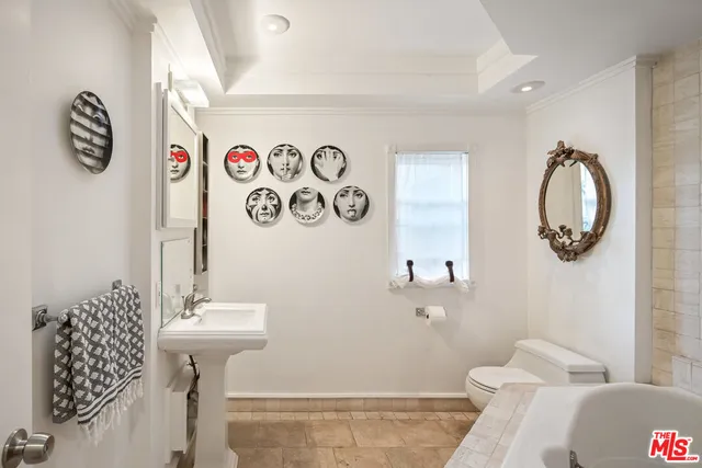 a bathroom with a sink mirror and toilet
