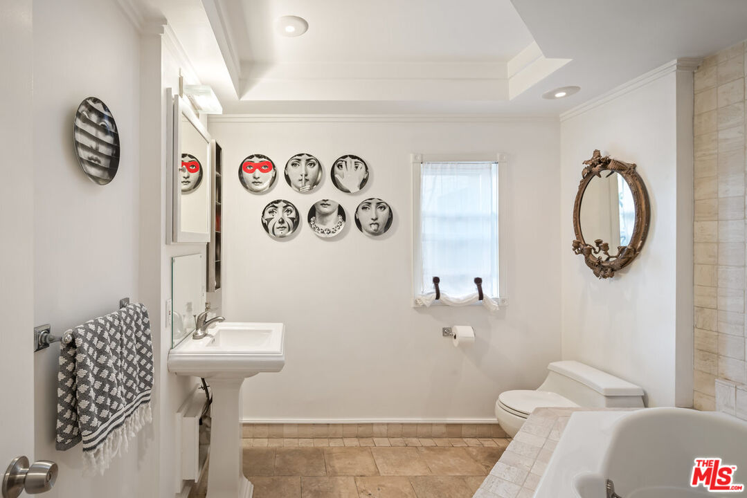 7770 Firenze Avenue Los Angeles, CA 90046 - Photo 22 of 32 a bathroom with a sink mirror and toilet