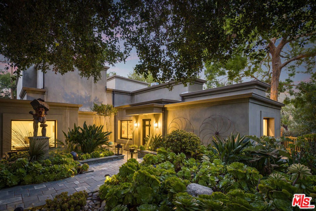 7770 Firenze Avenue Los Angeles, CA 90046 - Photo 26 of 32 a yellow house with trees in front of it