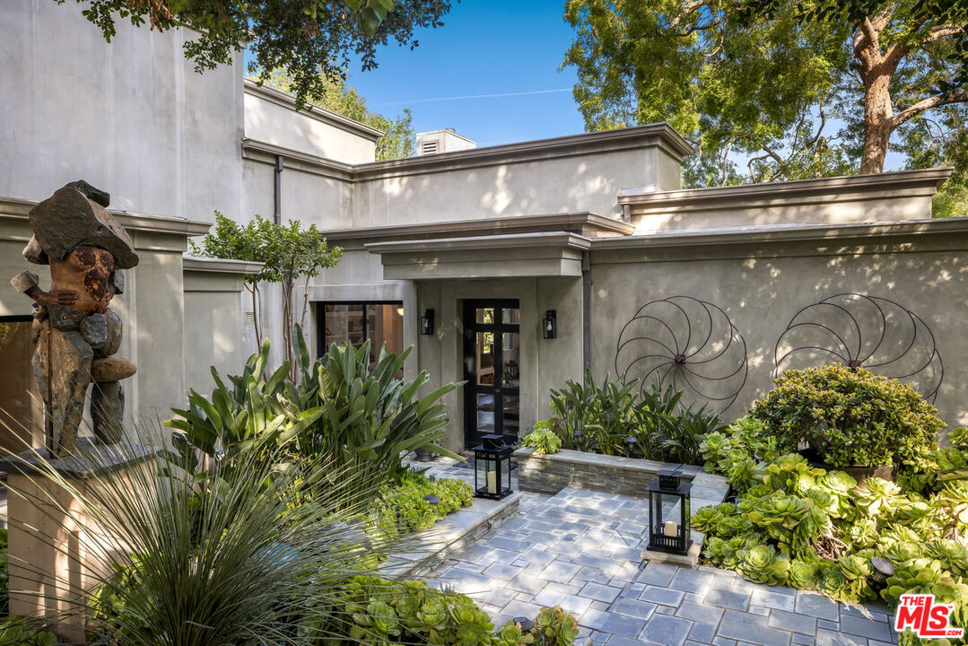 7770 Firenze Avenue Los Angeles, CA 90046 - Photo 3 of 32 a front view of a house with garden