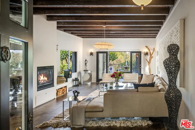 a living room with furniture and a floor to ceiling window