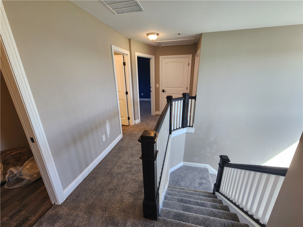 7441 Dodson Road Brookville, OH 45309 - Photo 18 of 50 This spacious hallway features carpeted flooring and leads to multiple rooms.