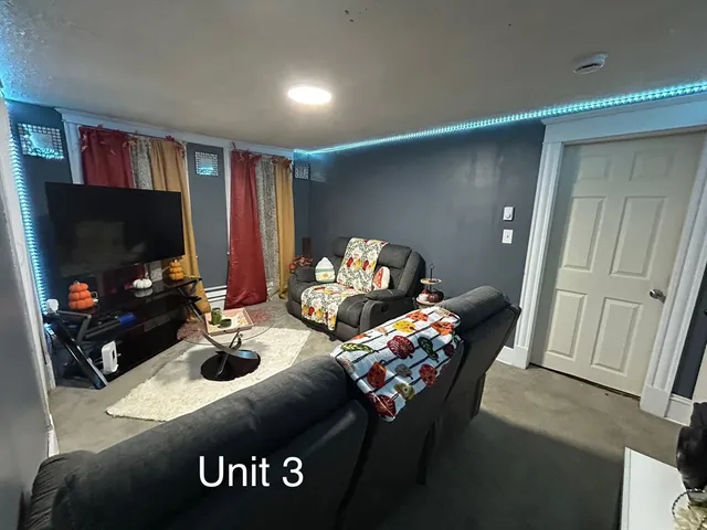 a bedroom with furniture and a flat screen tv