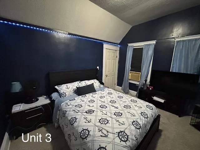 a bedroom with a bed and a dresser in it