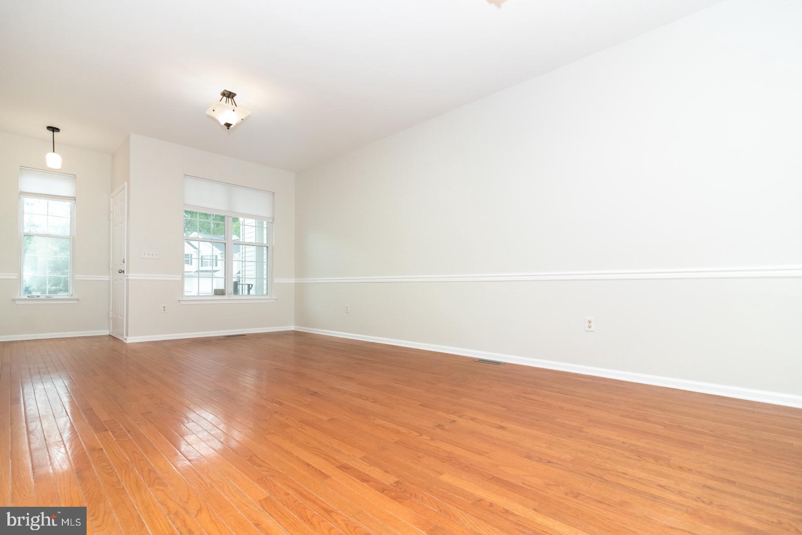226 Hawthorne Way Riverside, NJ 08075 - Photo 3 of 32 an empty room with wooden floor and windows