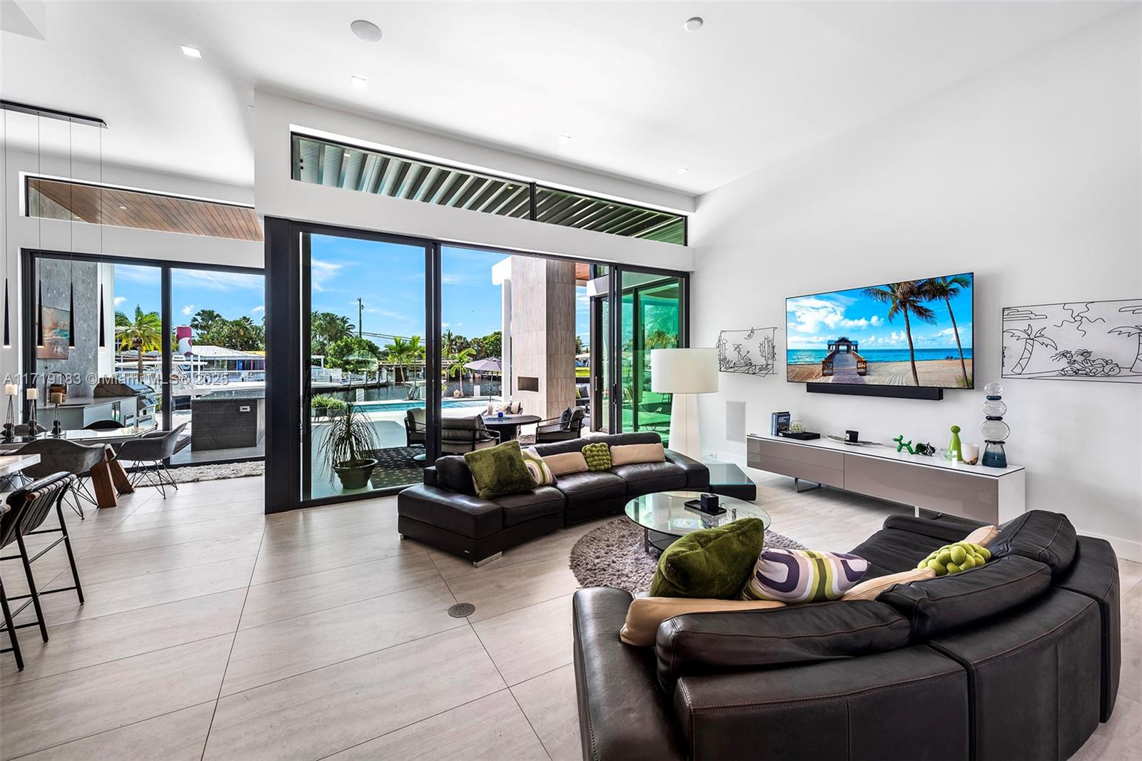 3701 Northeast 26th Avenue Lighthouse Point, FL 33064 - Photo 11 of 65 a living room with furniture and a flat screen tv