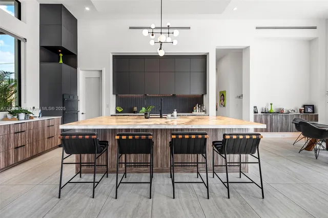 a kitchen with a table chairs and a chandelier