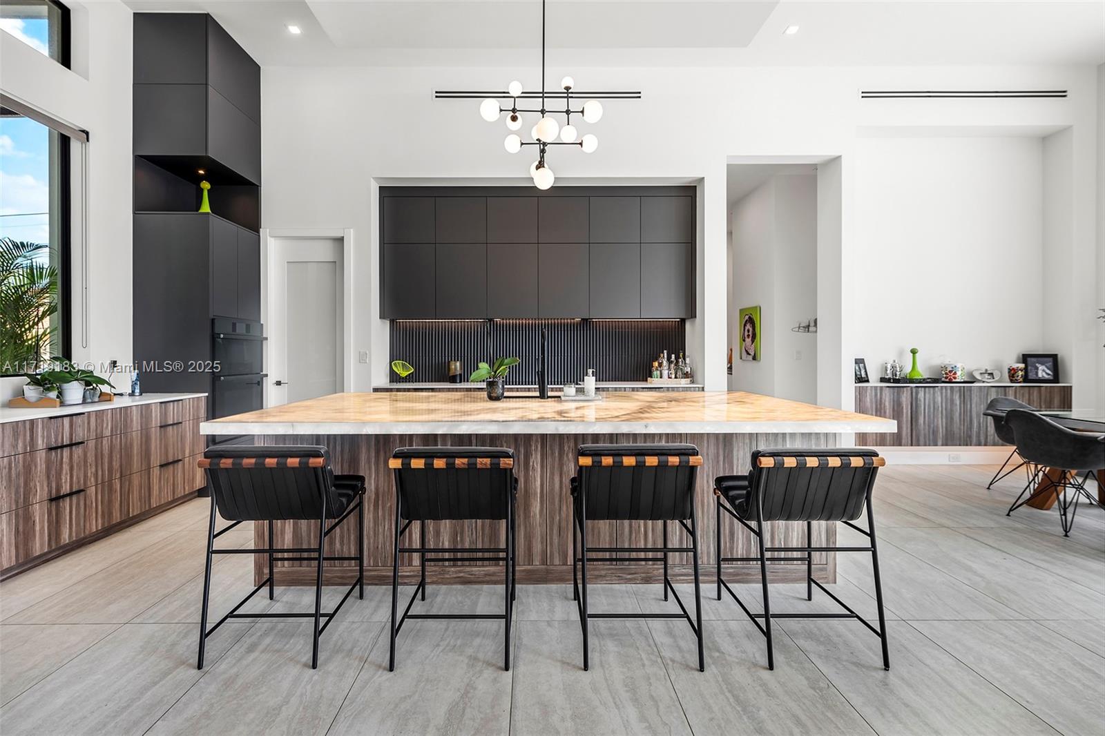 3701 Northeast 26th Avenue Lighthouse Point, FL 33064 - Photo 15 of 65 a view of a dining room with furniture wooden floor and chandelier