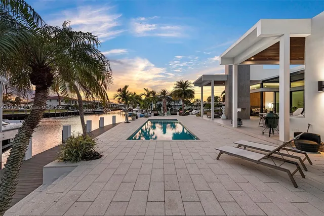 a swimming pool with outdoor seating and yard