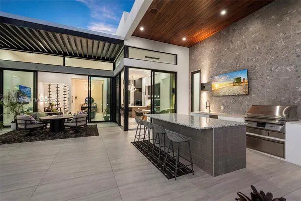 a living room with furniture and a floor to ceiling window