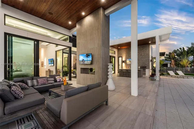 a living room with furniture and a floor to ceiling window