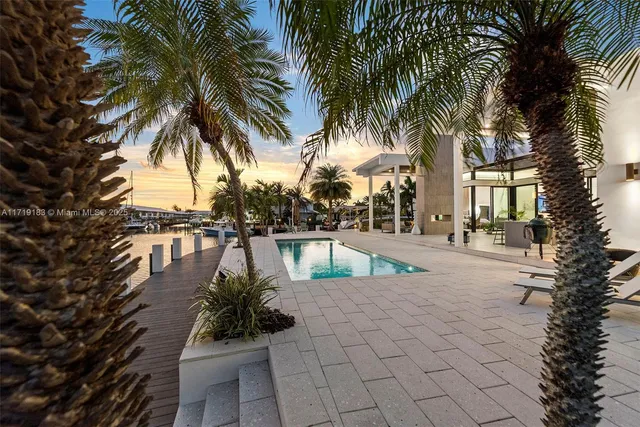 a bedroom with a bed and a potted plant next to a window